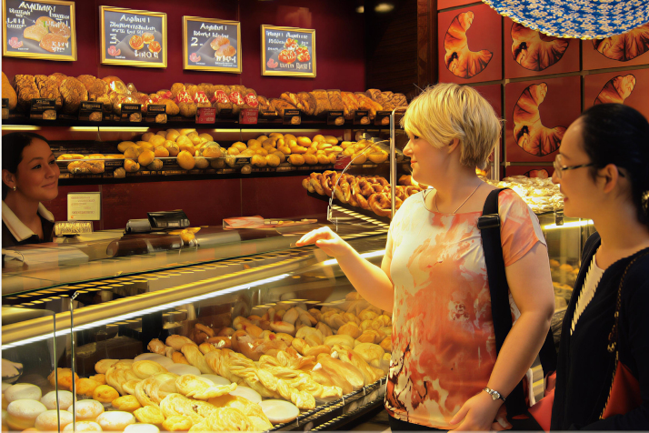 Eva at the bakery with her student