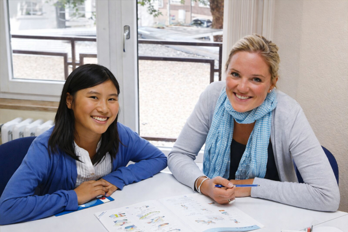 A girl studying with her teacher