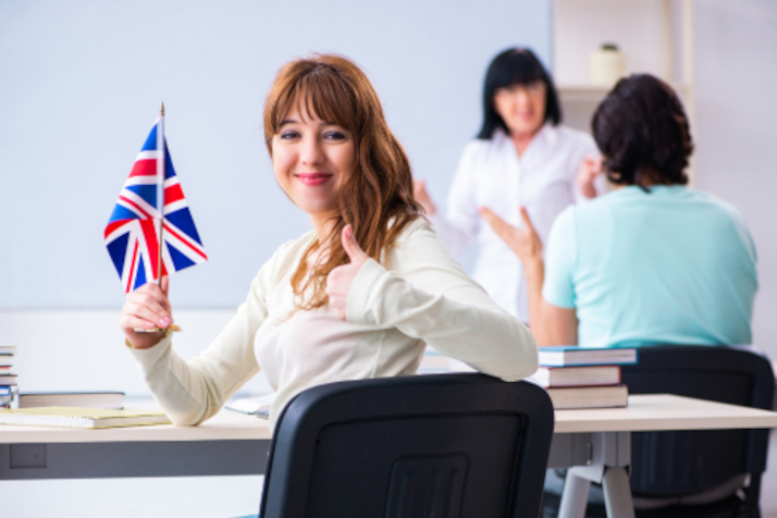 A woman holding a flag of the United Kingdom